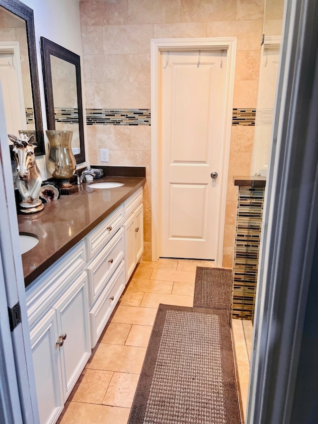 bathroom featuring vanity, tile walls, and tile patterned flooring