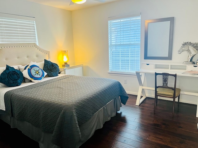 bedroom featuring dark wood-type flooring, ceiling fan, and multiple windows