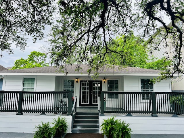 2817 Houston Ave, Houston, TX 77009 - ranch-style house featuring a porch, french doors, and a shingled roof