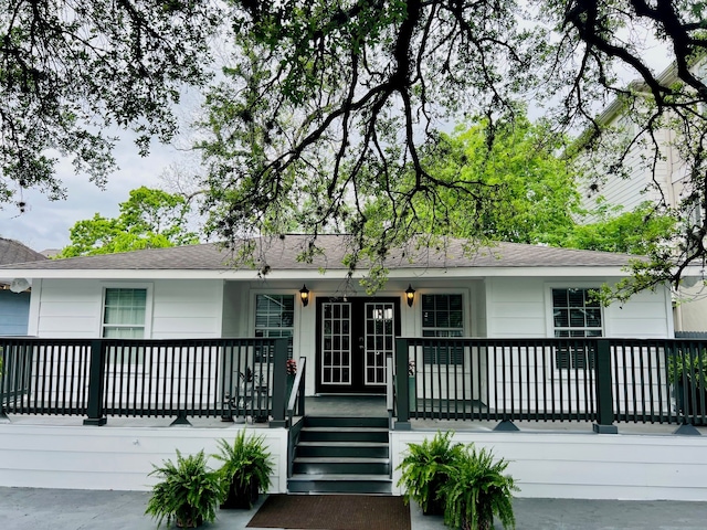 2817 Houston Ave, Houston, TX 77009 - ranch-style home featuring covered porch, french doors, and roof with shingles