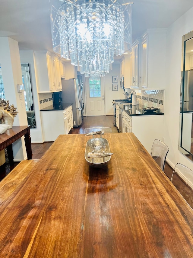 dining area with dark hardwood / wood-style flooring and a notable chandelier