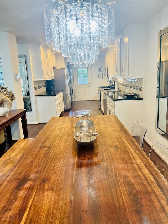 2817 Houston Ave, Houston, TX 77009 - dining area featuring a chandelier and dark wood-style flooring