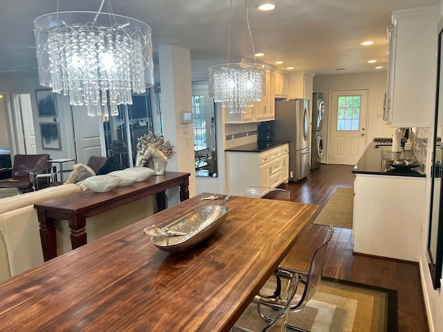 2817 Houston Ave, Houston, TX 77009 - dining space with a chandelier, dark wood-style floors, recessed lighting, and stacked washer and clothes dryer