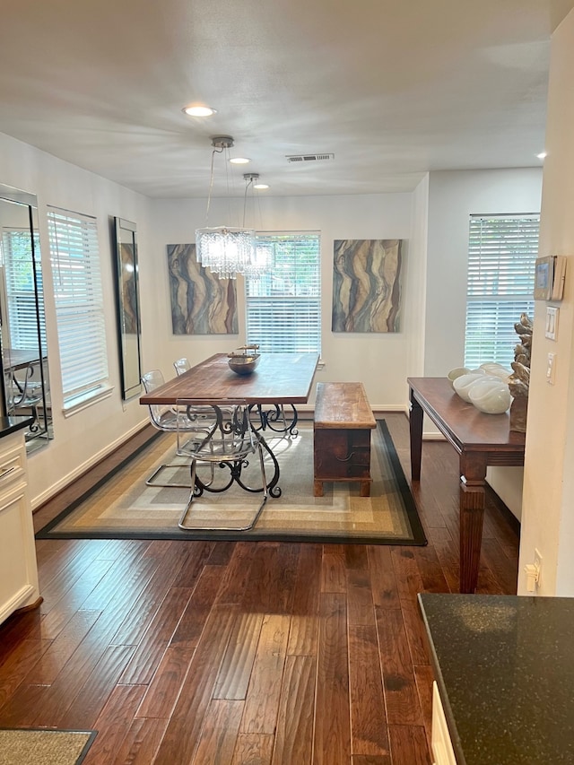 dining room with dark wood-type flooring and plenty of natural light