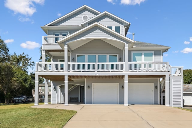 coastal home featuring a garage and a front yard