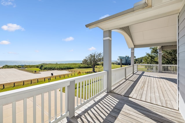 wooden terrace featuring a water view