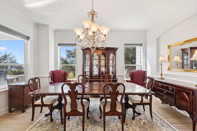 dining space featuring a wealth of natural light, light hardwood / wood-style floors, and crown molding