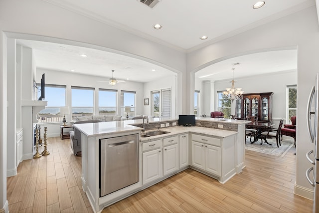 kitchen featuring hanging light fixtures, sink, light hardwood / wood-style floors, white cabinets, and dishwasher