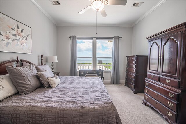 carpeted bedroom with ornamental molding and ceiling fan