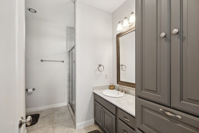 bathroom featuring walk in shower, vanity, and tile patterned floors