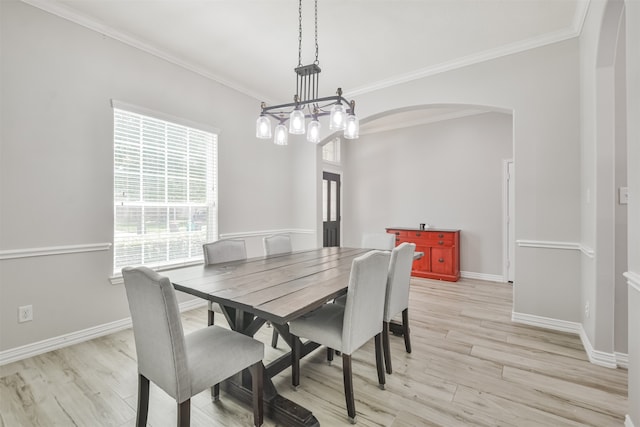 dining room with light wood-type flooring, a chandelier, and ornamental molding