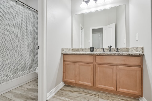 bathroom featuring toilet, vanity, a shower with shower curtain, and hardwood / wood-style flooring