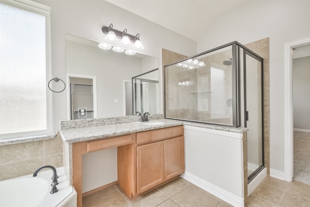 bathroom with a wealth of natural light, shower with separate bathtub, and lofted ceiling