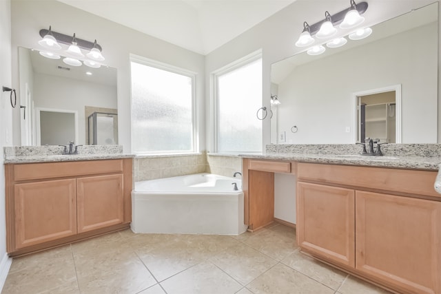 bathroom with plus walk in shower, vanity, and tile patterned floors