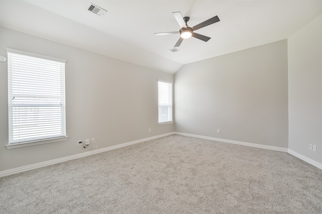 empty room featuring carpet floors, lofted ceiling, and ceiling fan