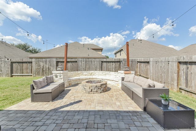 view of patio with an outdoor living space with a fire pit