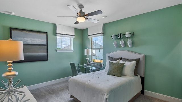 bedroom with ceiling fan, baseboards, and dark colored carpet