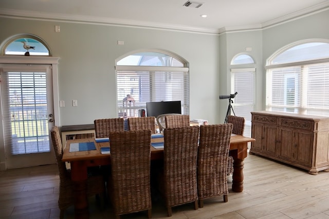 dining space with plenty of natural light, light hardwood / wood-style flooring, and ornamental molding