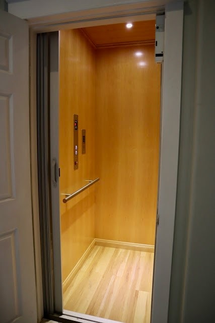 room details featuring elevator and wood-type flooring