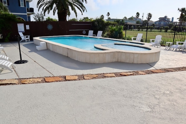 view of swimming pool featuring a community hot tub and a patio