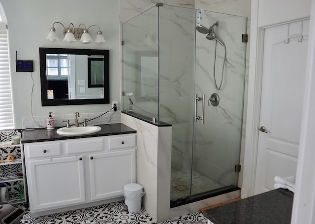 bathroom with a shower with door and vanity