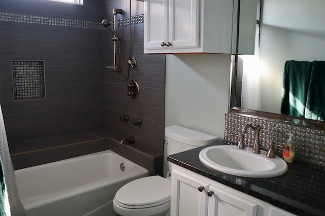 full bathroom with vanity, toilet, and tiled shower / bath