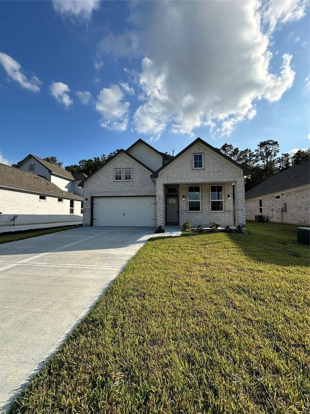 view of front of property with a front yard and a garage