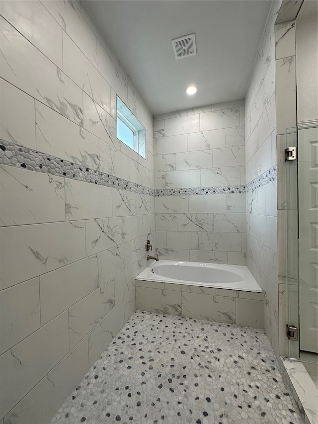 bathroom with separate shower and tub