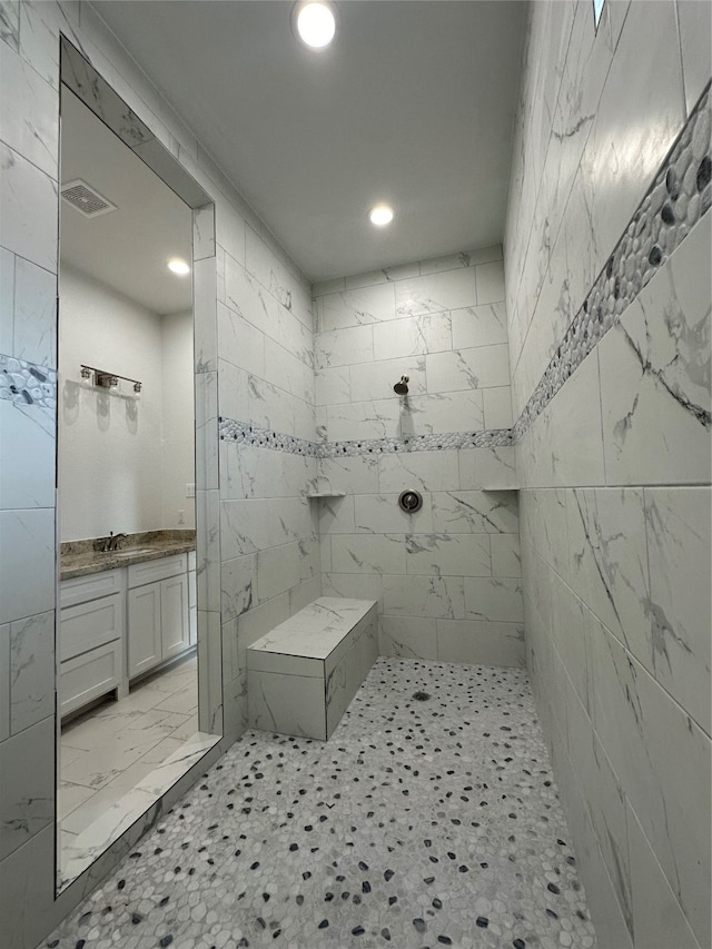 bathroom featuring vanity and a tile shower