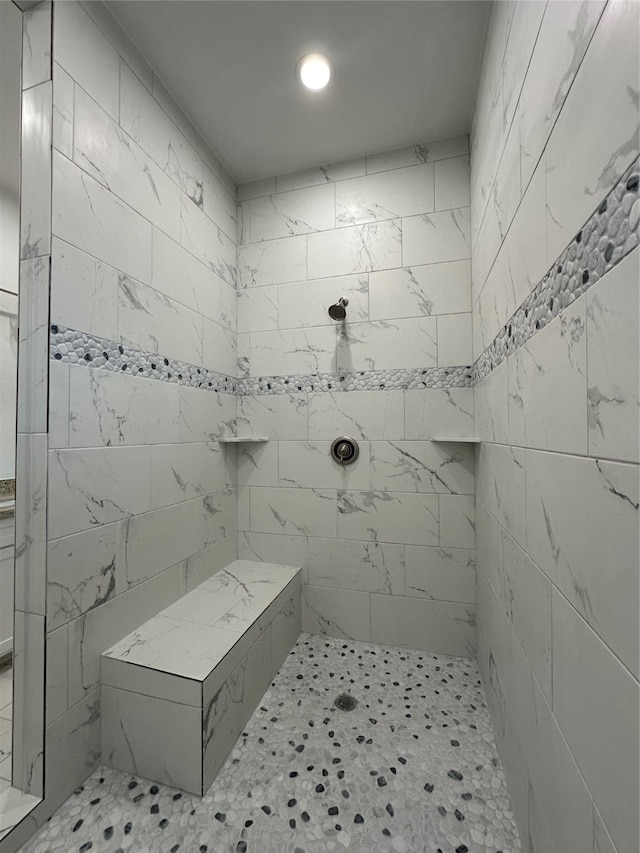 bathroom with tiled shower