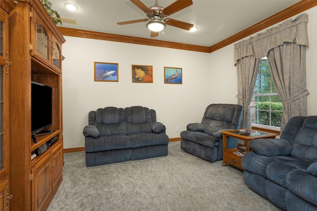 living area featuring carpet floors, a ceiling fan, baseboards, and crown molding