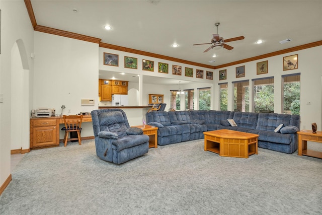 carpeted living room with baseboards, visible vents, arched walkways, ornamental molding, and recessed lighting