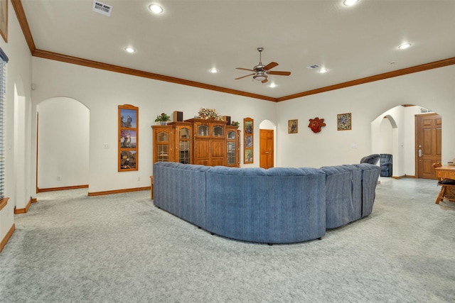 living area with carpet floors, arched walkways, visible vents, a ceiling fan, and baseboards