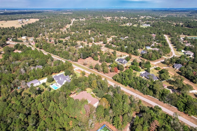 birds eye view of property featuring a forest view