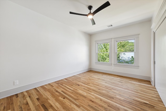 empty room with light hardwood / wood-style floors and ceiling fan