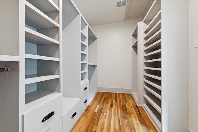 spacious closet featuring light hardwood / wood-style floors