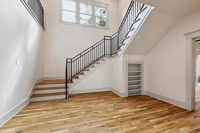 stairs with hardwood / wood-style flooring