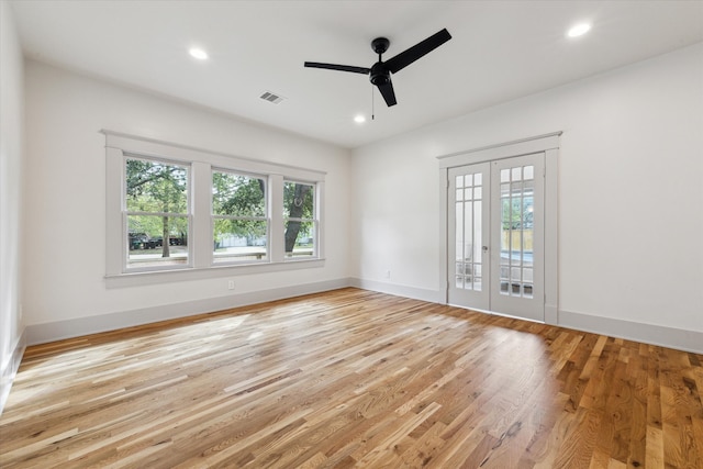 unfurnished room with ceiling fan, light wood-type flooring, and french doors