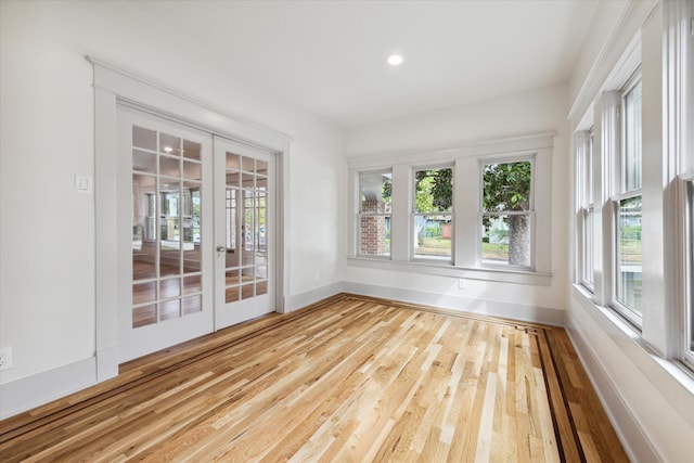 unfurnished sunroom featuring french doors