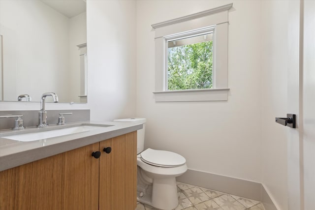 bathroom with vanity, tile patterned floors, and toilet