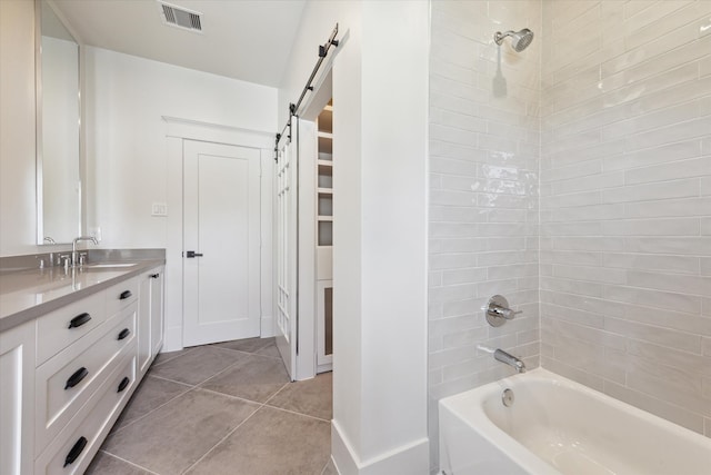 bathroom with vanity, tile patterned floors, and tiled shower / bath