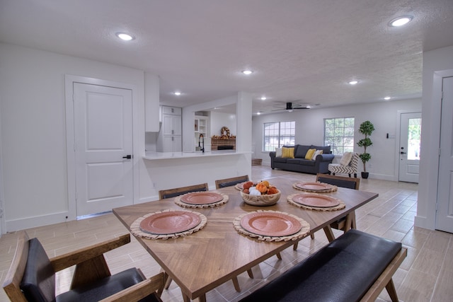 dining room featuring a textured ceiling and ceiling fan