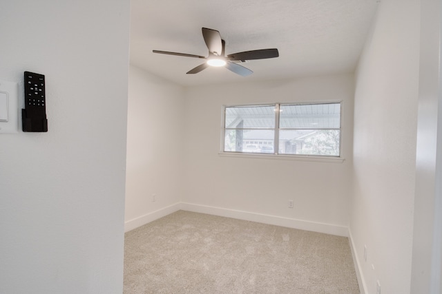 spare room with light carpet and ceiling fan