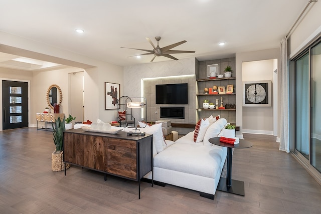 living room featuring ceiling fan and dark hardwood / wood-style floors