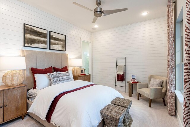 carpeted bedroom with wood walls and ceiling fan