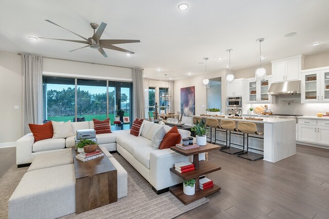 living room with wood-type flooring and ceiling fan