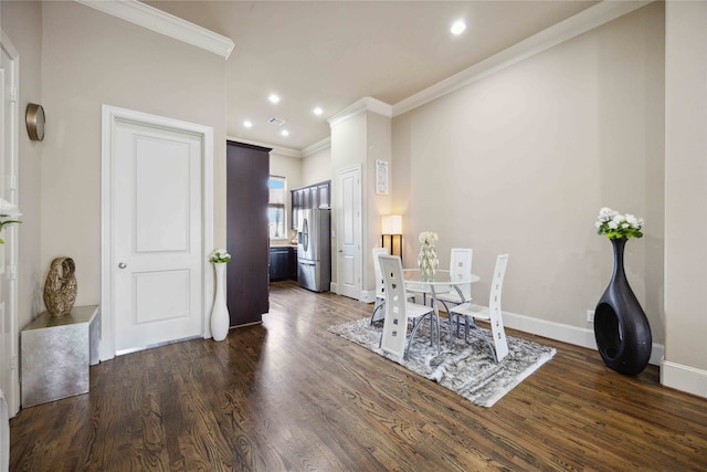 dining room featuring dark hardwood / wood-style flooring and crown molding