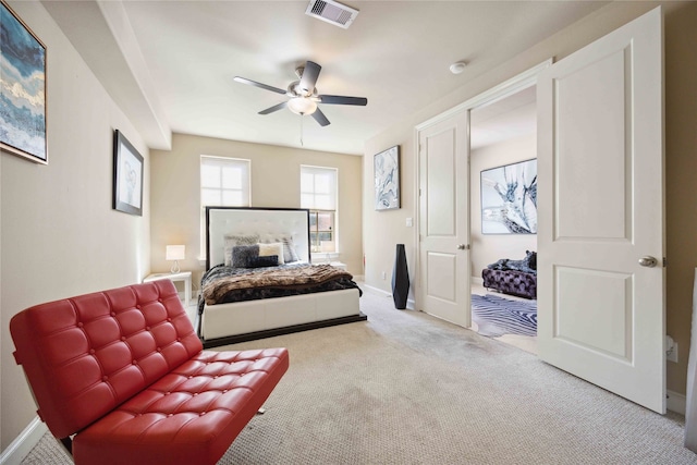 bedroom featuring ceiling fan and light carpet