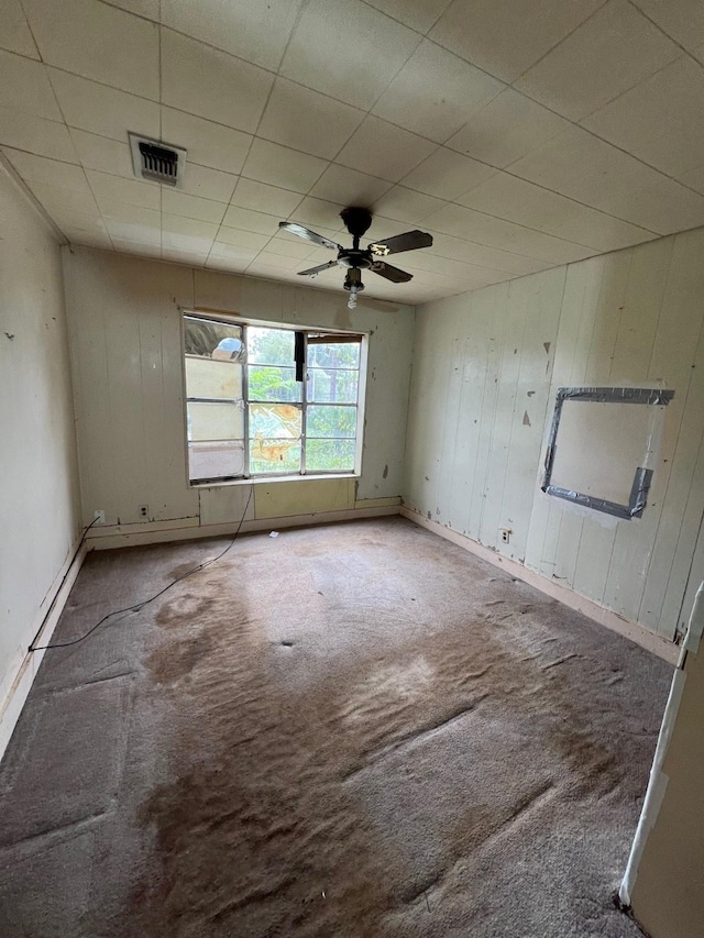 107 Thompson St, El Campo, TX 77437 - carpeted spare room with ceiling fan and wooden walls