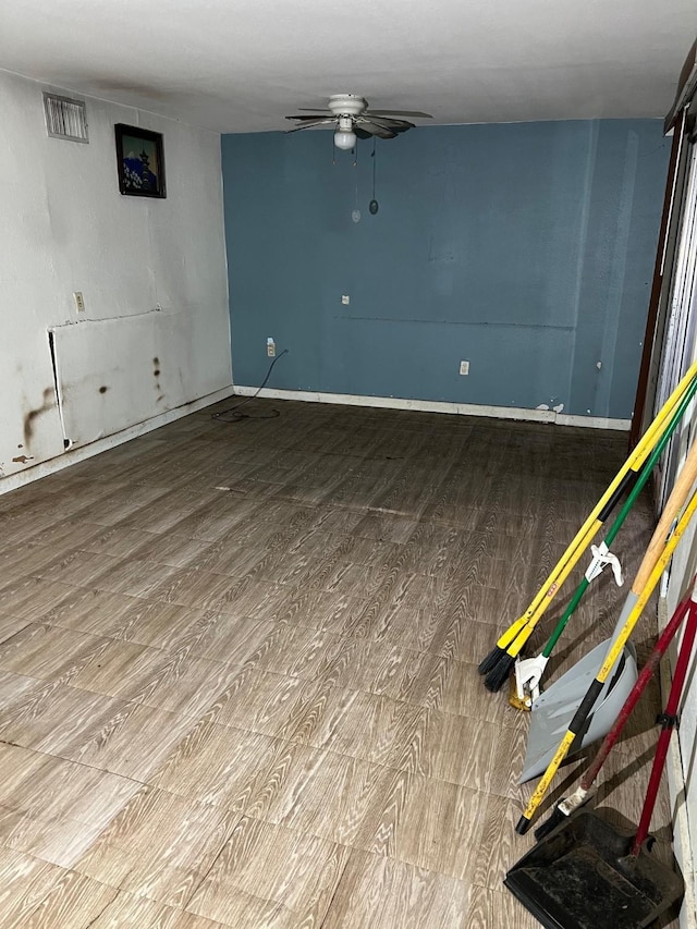 107 Thompson St, El Campo, TX 77437 - empty room featuring wood finished floors, ceiling fan, and baseboards